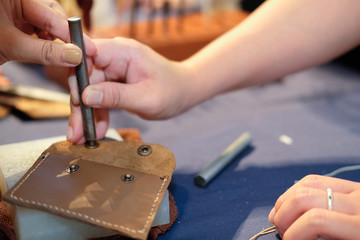 craftsman pinching button on leather bag. handmade DIY handicraft