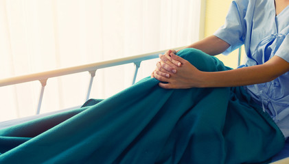 Female patients on the bed using hand coordination indicate loneliness.