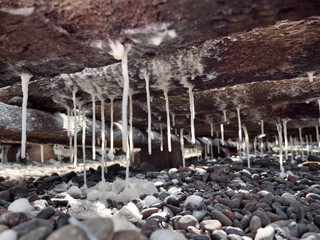 Production of sea salt in the Bali,Indonesia. Salt crystallizes out of the ground in salt farm,...