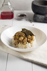 chicken and pork adobo over yellow rice, filipino food