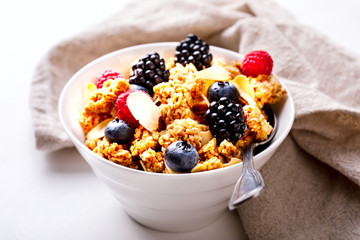 Granola Cereal bar with Strawberries blueberries and Milk on light Background . Muesli Breakfast. Healthy Food sweet dessert snack. Diet Nutrition Concept. Vegetarian food. Copy space for Text.