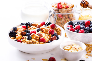 Granola Cereal bar with Strawberries blueberries and Milk on light Background . Muesli Breakfast. Healthy Food sweet dessert snack. Diet Nutrition Concept. Vegetarian food.