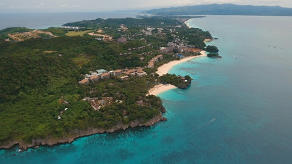 Aerial view of beautiful tropical island with white sand beach, Boracay, hotels and tourists. Tropical lagoon with turquoise water and white sand. Beautiful sky, sea, beach, resort. Seascape: Ocean