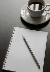 Black Desk With Coffee, Paper And Pen