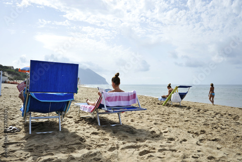 Women On The Beach Relaxing By Reading Gossip Magazines Sabaudia Women On The Beach Relaxing By Reading Gossip Magazines Sabaudia Lazio Italy