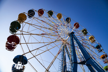 Fototapeta premium Ferris wheel against the blue sky.