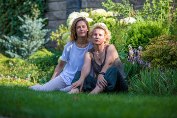 Mom and daughter in a beautiful garden