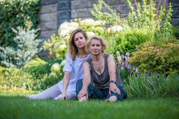 Mom and daughter in a beautiful garden