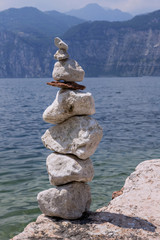 Stones stacked on a background of lake and mountains