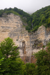 Fototapeta premium Panorama of Kinche cascading high thin waterfall and cloud