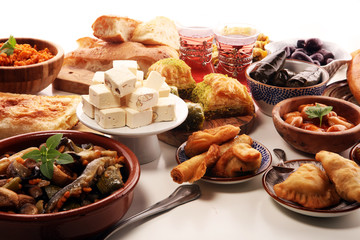 Middle eastern or arabic dishes and assorted meze, concrete rustic background. sambusak. Turkish Dessert Baklava with pistachio. Sarma. Halal food. Lebanese