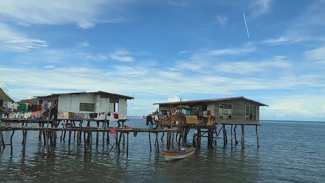 A scenic shot of run down houses on the ocean..