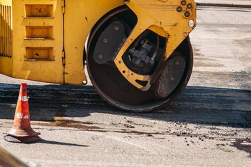 Road roller building the new asphalt road  at a road construction site