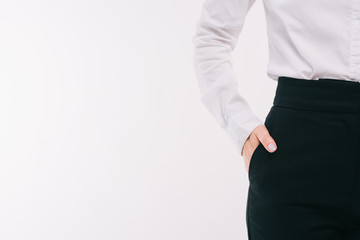 cropped image of businesswoman standing with hand in pocket isolated on white