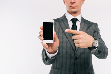 cropped image of businessman pointing on smartphone with blank screen isolated on white