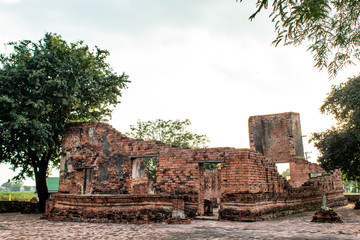 Fototapeta na wymiar The old tower built of bricks is damaged at Worachet temple in Ayutthaya ,Thailand.