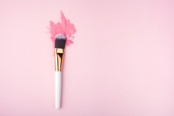 Makeup Brush on pink Background with Colorful Pigment Powder. Top view