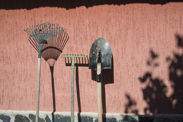 Garden tools leaning on the wall