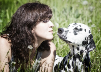 Pretty beautiful woman with long dark hair with dalmatian dog