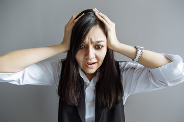 Naklejka premium Stress. Business woman frustrated. Funny image of young Caucasian Asian businesswoman