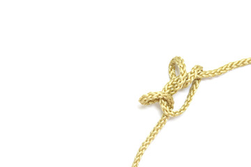 close up of gold rope on white background