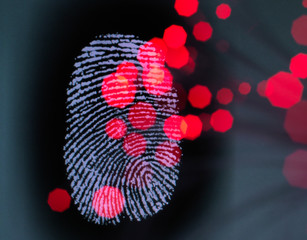 Data infecting a finger print identity on a screen to illustrate hacking and cyber crime