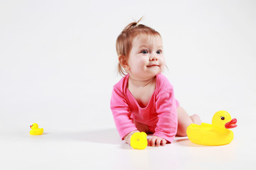 little girl is played with dents in the studio on a white background