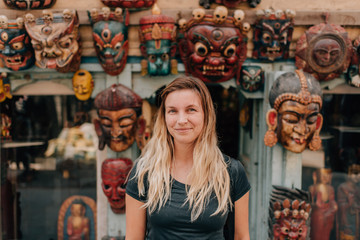 Woman in front of masks, Kathmandu, Nepal