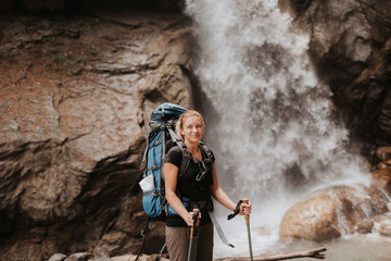 Hiker in front of waterfall, Annapurna Circuit, the Himalayas, Manang, Nepal