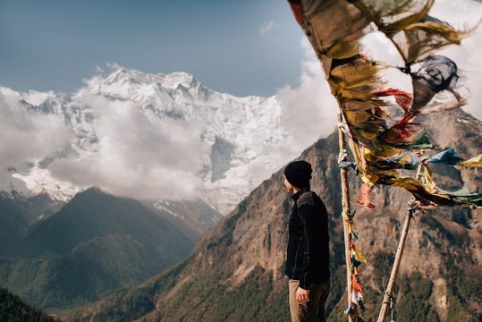 Hiker on peak, Annapurna Circuit,  view to Annapurna 2 mountain, the Himalayas, Manang, Nepal