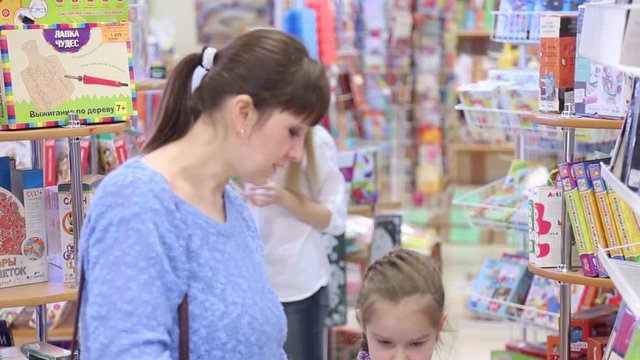 Mom and daughter choose school supplies in the stationery store