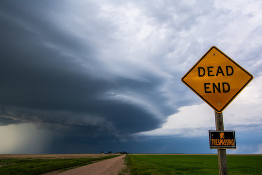 Rotating storm moves past "dead end" and "no trespassing" signage on prairie northeast of Big Springs, Nebraska