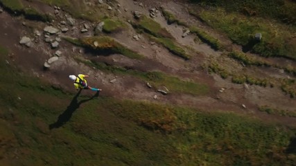 Top view of two hikers fast running in the Carpathians mountains drone footage