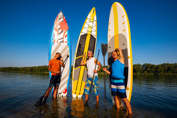 Happy friends with SUP boards