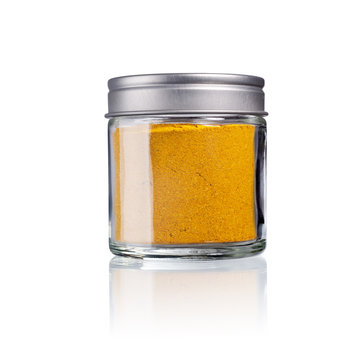 curry powder in a glas with metal lid, isolated on white