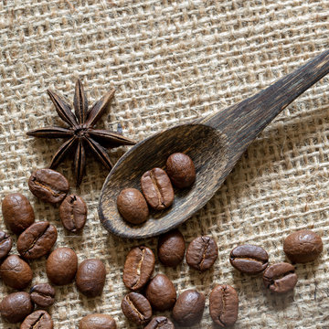 roasted coffee in a wooden spoon on canvas