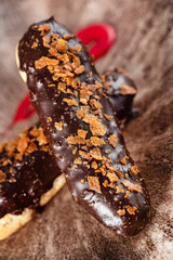 Eclairs or profiteroles with black chocolate