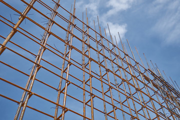 Steel reinforcement bar and timber form works at construction site on blue sky background