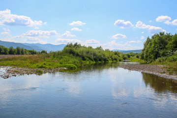 The mountains with the river on a sunny day. Ukrainian Carpathian Mountains