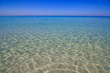 Fototapeta na wymiar Crystal clear sea view. Pure blue beach water in Corsica