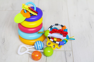 Baby Toys on White Wooden Background. Child Development Concept 