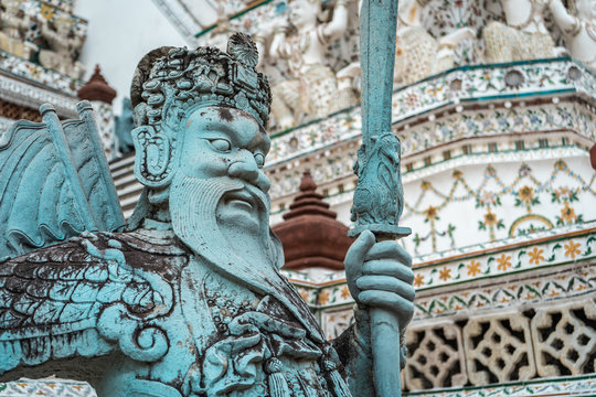 Closeup shot of stone warrior statue in Wat Arun temple, Bangkok, Thailand
