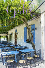 Outdoor  Italian Restaurant with Blue Chairs and Tables .Restaurant Exterior 