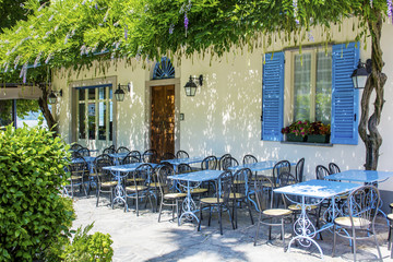 Outdoor  Italian Restaurant with Blue Chairs and Tables .Restaurant Exterior 