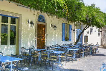 Outdoor  Italian Restaurant with Blue Chairs and Tables .Restaurant Exterior 