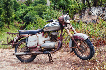 The thrown old rusty brown vintage motorcycle