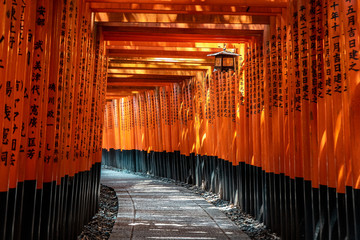 Japanese red Torii gates with black writings in Fushimi Inari-taisha Shrine, Kyoto, Japan