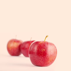 red ripe apples on a beige background