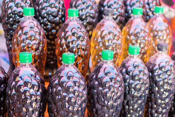 A number of wine in plastic bottles.