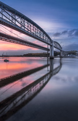 Fototapeta na wymiar Dawn Reflectitions, Tamar Bridges, Cornwall